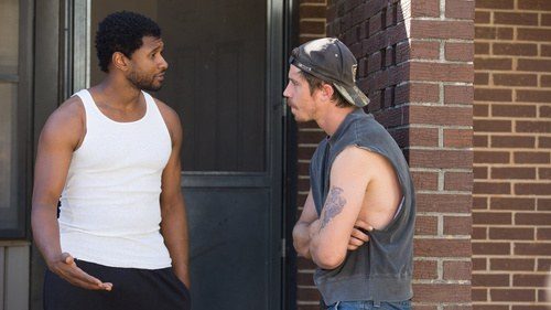 Costume design by Anette Cseri for the film Burden: two men facing each other in a doorway, one in a white vest